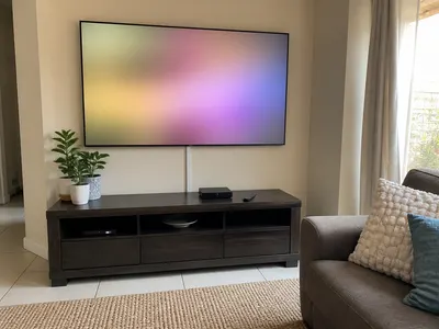 Decoder and wall-mounted TV set up in a family lounge